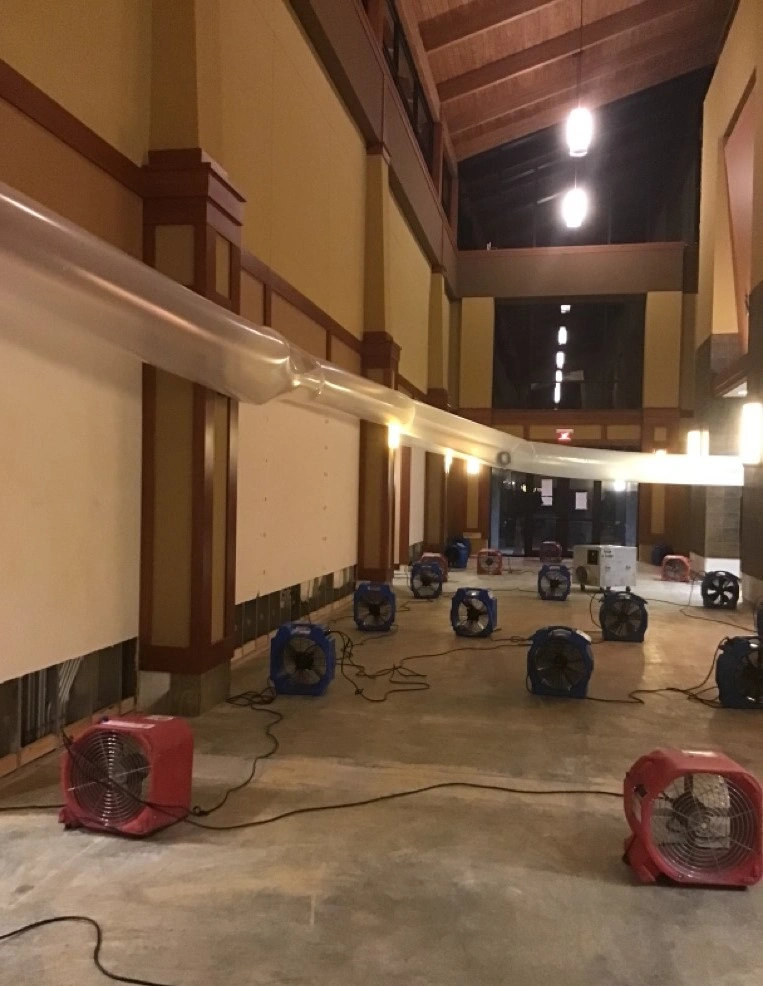 College auditorium water damage restoration with air movers, dehumidifiers, and desiccants